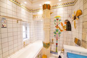 a bathroom with a tub and a shower with tiles at Château de Bissieux in Châtillon-sur-Chalaronne +19 photos