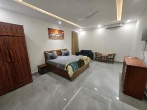 a bedroom with a bed and a table in it at Aadhya Hotel & Adhira Restaurant in Orchha