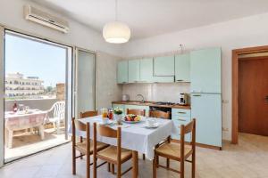 a kitchen and dining room with a table and chairs at Residence Ionian Gallipoli in Gallipoli