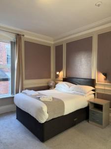 a bedroom with a large bed and a window at The Avenue Hotel in Grantham +96 photos
