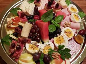 a plate of food with eggs and fruit on a table at Gohrischer Hof Anno 1798 in Kurort Gohrisch +18 photos