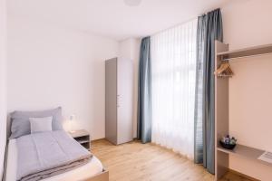 a bedroom with a bed and a large window at Bed and Breakfast Kloster Frienisberg in Seedorf