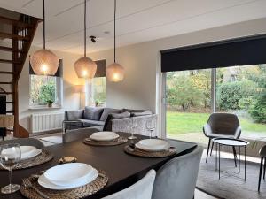 a living room with a table and a couch at Huize Sallandse Stilte in Heeten