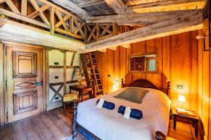 a bedroom with a bed in a room with wooden walls at Château de Bissieux in Châtillon-sur-Chalaronne