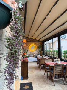 a room with tables and chairs and a vine at LUTA Urla in Urla