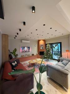 a living room with a couch and a christmas tree at LUTA Urla in Urla