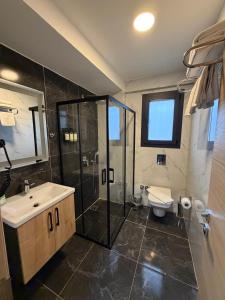 a bathroom with a sink and a shower and a toilet at LUTA Urla in Urla +38 photos