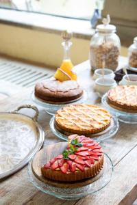 a table topped with pies on plates with strawberries on top at Fattoria di Maiano in Fiesole