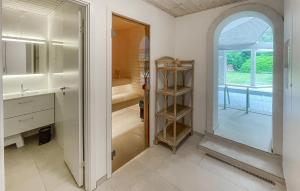a bathroom with a sink and a mirror at Nice Home In Højby With Sauna in Højby +30 photos