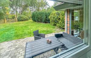 a patio with a table and chairs in a yard at Nice Home In Højby With Sauna in Højby