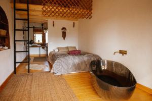 a bedroom with a large tub in the corner of a room at Herdade da Maceira in São Luis