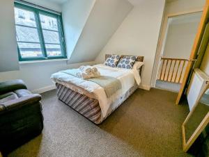 a bedroom with a bed with two teddy bears on it at City Center Gem-4Bd House! in Edinburgh