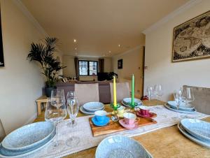 a dining room table with plates and wine glasses at City Center Gem-4Bd House! in Edinburgh