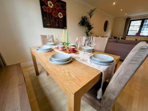 a dining room table with plates and glasses on it at City Center Gem-4Bd House! in Edinburgh
