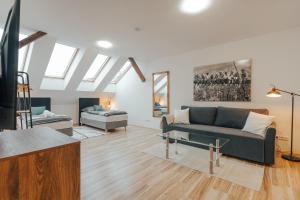 a living room with a couch and a table at Apartmá Oberleithnerův palac in Šumperk
