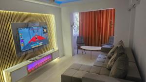 a living room with a couch and a flat screen tv at DNY Home 2 in Giurgiu
