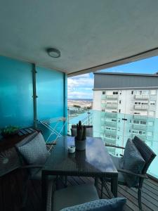 a balcony with a table and chairs and a building at Gibraltar Luxe Stay in Gibraltar