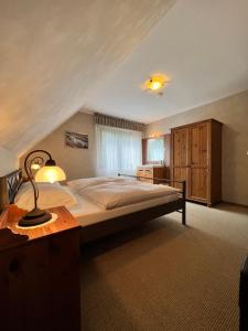 a bedroom with a bed and a desk with a lamp at Aparts4ring 5 Nürburg in Nürburg +21 photos