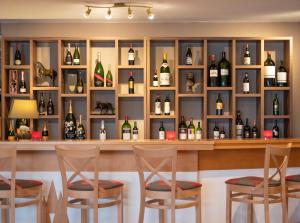 a bar with a bunch of bottles of wine at Waldhotel Doldenhorn in Kandersteg