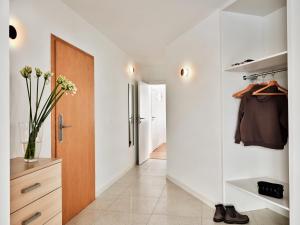 a hallway with a pivot door and a closet at Apartamenty Media Park in Warsaw +62 photos