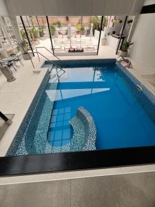a large swimming pool with blue tile on a building at HDA Miraflores in Termas de Río Hondo
