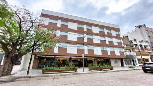 a large building with benches in front of it at HDA Miraflores in Termas de Río Hondo