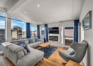 a living room with a couch and chairs and windows at Finest Retreats - Silverwood Deluxe Chalet in Errol