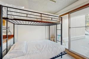 a bedroom with a bunk bed and a balcony at Iron Horse Resort #C1083 in Winter Park +36 photos