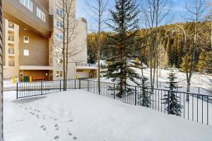 a balcony of a building with footprints in the snow at Iron Horse Resort #C1083 in Winter Park
