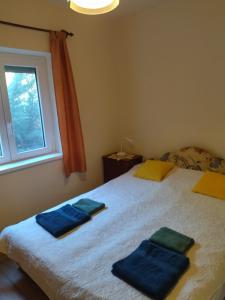 a bedroom with a bed with two blue towels on it at Babarczi Üdülőház in Kiskunmajsa +24 photos