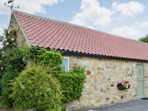 a stone cottage with a red roof at Bilsdale - 25566 in Nether Silton