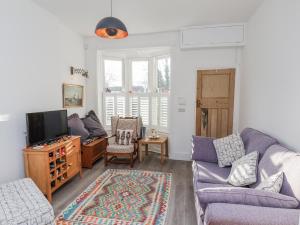 a living room with a couch and a tv at 1 Castle Terrace in Thirsk
