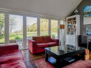 a living room with two couches and a coffee table at Cliff Cottage in Port Appin