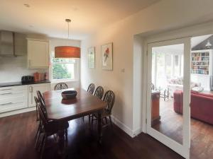 a kitchen and dining room with a table and chairs at Cliff Cottage in Port Appin