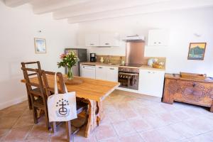 a kitchen with a wooden table and a stove at Château de Bissieux in Châtillon-sur-Chalaronne