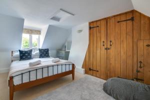 a bedroom with a bed and a large wooden cabinet at 4 Bed in Rottingdean oc-bbrott in Rottingdean