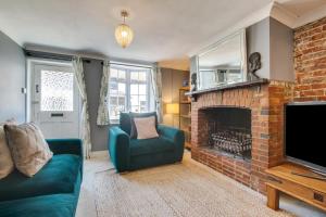 a living room with a couch and a fireplace at 4 Bed in Rottingdean oc-bbrott in Rottingdean