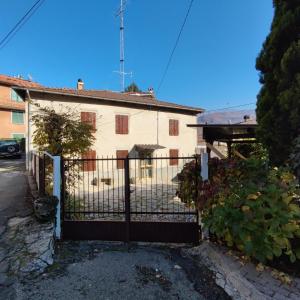 a house with a gate in front of it at Charme a Corniglio in Corniglio