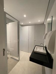 a bathroom with a sink and a shower at Social Hostel Café e Bar in Curitiba