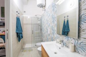 a bathroom with a sink and a shower at CasAmica by BarbarHouse in Vieste +10 photos
