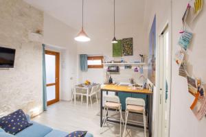 a kitchen and living room with a table and chairs at CasAmica by BarbarHouse in Vieste