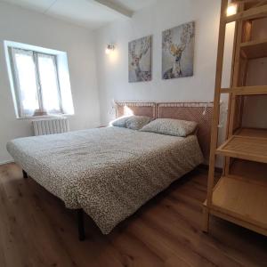 a bedroom with a bed and two pictures on the wall at Charme a Corniglio in Corniglio