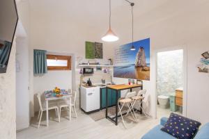 a kitchen with a counter and a table and chairs at CasAmica by BarbarHouse in Vieste