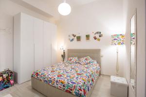 a bedroom with a bed with a colorful comforter at CasAmica by BarbarHouse in Vieste