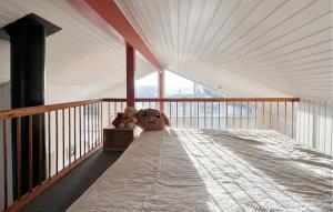 two teddy bears sitting on a bed on a balcony at Amazing Home In Juelsminde With House Sea View in Juelsminde +18 photos