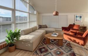 a living room with a couch and a table at Amazing Home In Juelsminde With House Sea View in Juelsminde