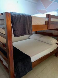 a group of bunk beds in a room at Hospedaje Villa Laura in Cite