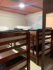 a group of bunk beds in a room at Hospedaje Villa Laura in Cite