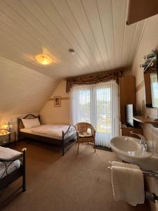 a bathroom with a bed and a sink in a room at Aparts4ring 5 Nürburg in Nürburg