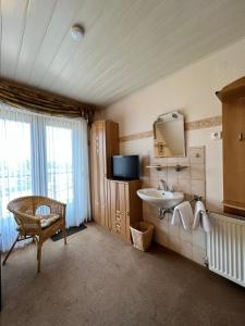 a bathroom with a sink and a mirror at Aparts4ring 5 Nürburg in Nürburg